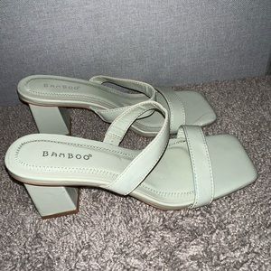 Light green heeled sandals.